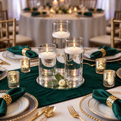 Lit floating candles in glass cylinders on a mirror tray with green table decor - thumbnail number 2