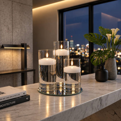 Lit floating candles in glass cylinders on a mirror tray on a marble counter with city view - thumbnail number 9