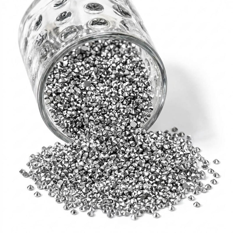 Sparkling silver faux diamond rhinestones spilling out of a glass jar onto a white background - thumbnail number 1