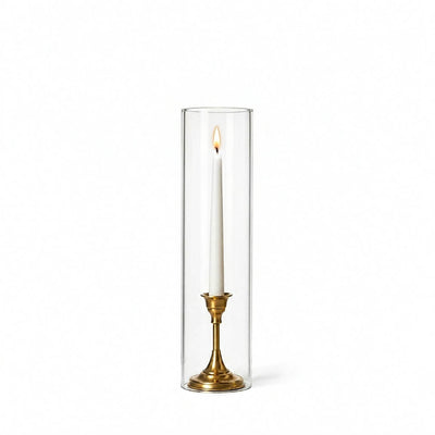 Lit white taper in a gold holder with a 4" x 16" chimney glass candle shade - thumbnail number 3