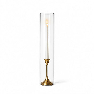 A lit white taper in a gold holder with a 4" x 18" chimney glass candle shade - thumbnail number 3
