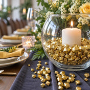 Glass bowl filled with gold acrylic ice beads and a candle on a table runner - thumbnail number 2