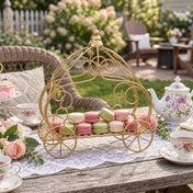 Gold carriage centerpiece holding colorful macarons on an outdoor table - thumbnail number 8