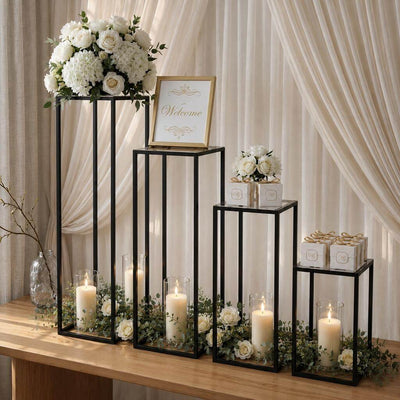 Black metal display stands with floral arrangements, candles, and a welcome sign for a wedding - thumbnail number 5