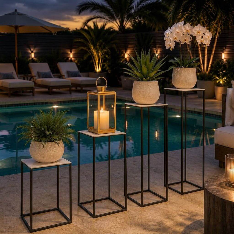 Tall black metal display stands with plants and a candle lantern by a swimming pool - thumbnail number 7