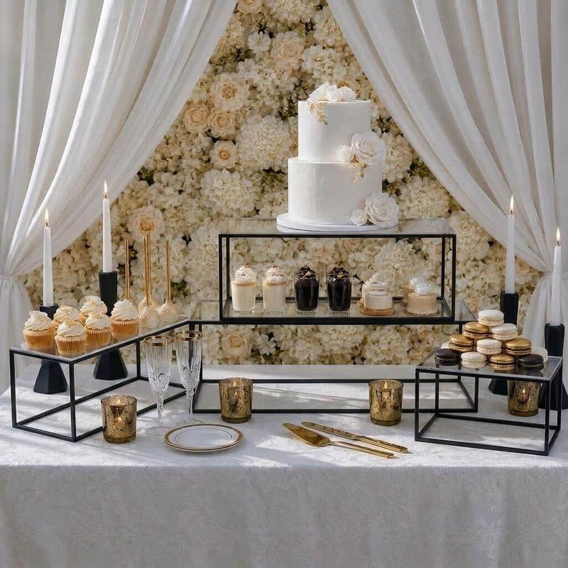 Multi-tiered clear acrylic and black metal display stands holding a wedding cake and desserts - thumbnail number 5