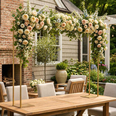 Gold metal arch stand over a wooden table, decorated with flowers - thumbnail number 9