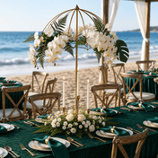Gold metal umbrella flower stand centerpiece with white orchids and candles at a beach wedding - thumbnail number 3