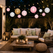 Mixed blush and gold paper lanterns hanging over an outdoor patio seating area - thumbnail number 5