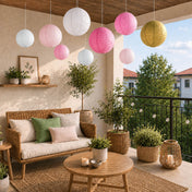 Mixed blush and gold paper lanterns hanging on a covered outdoor balcony patio - thumbnail number 7
