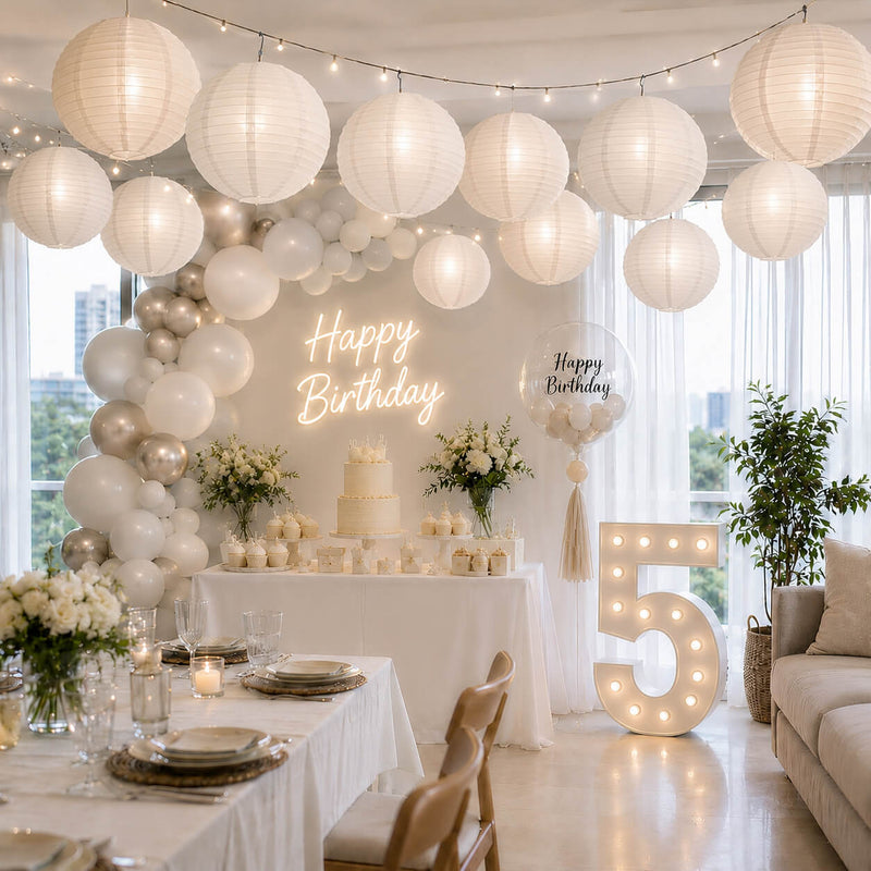 White paper lanterns hanging as decoration above a birthday party table setup - thumbnail number 2