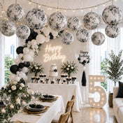 Black and white French toile paper lanterns hanging over a fifth birthday party - thumbnail number 2