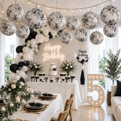 Black and white French toile paper lanterns hanging over a fifth birthday party - thumbnail number 2