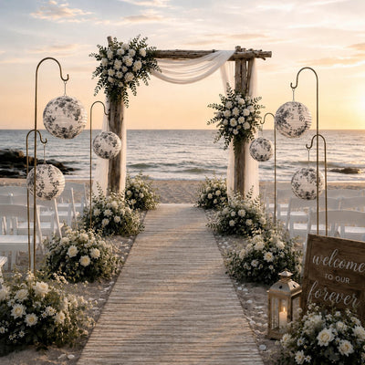 Black and white French toile paper lanterns hanging on shepherd hooks at a beach wedding ceremony - thumbnail number 4