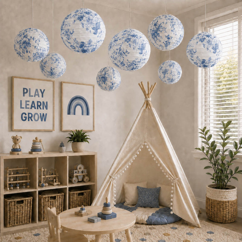 Blue floral paper lanterns hang above a cozy nursery room with a play tent - thumbnail number 10