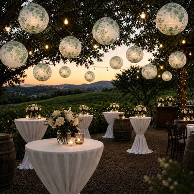 Green floral paper lanterns hang over an outdoor winery cocktail event - thumbnail number 7