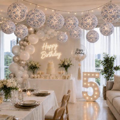 Blue and white French toile paper lanterns hanging over a fifth birthday party setup - thumbnail number 2