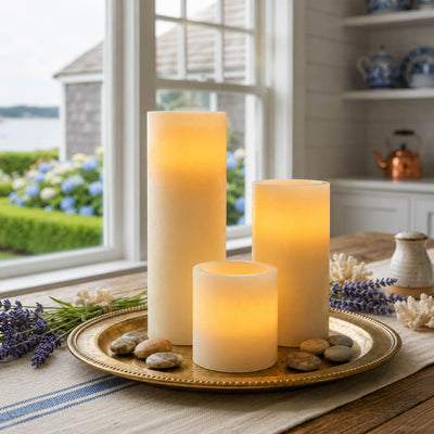 Three flameless pillar candles on a gold tray by the window - thumbnail number 7