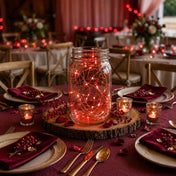 Red LED fairy lights inside a glass mason jar centerpiece on a rustic wedding table - thumbnail number 5
