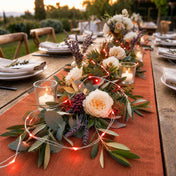 Red LED fairy lights woven into a rustic table centerpiece with flowers and candles - thumbnail number 6