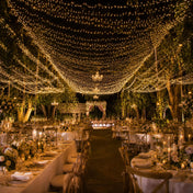 10ft by 50ft warm white LED fairy lights creating a canopy over an outdoor wedding reception - thumbnail number 6