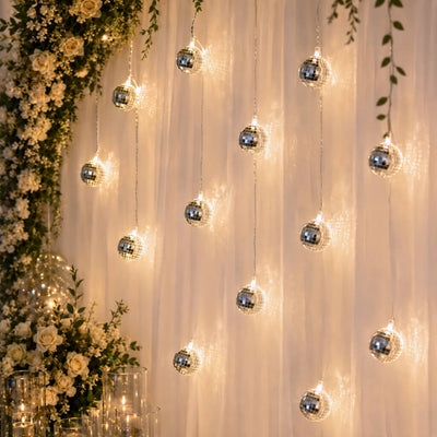 Disco ball string lights hanging as a backdrop behind a wedding floral arrangement - thumbnail number 7