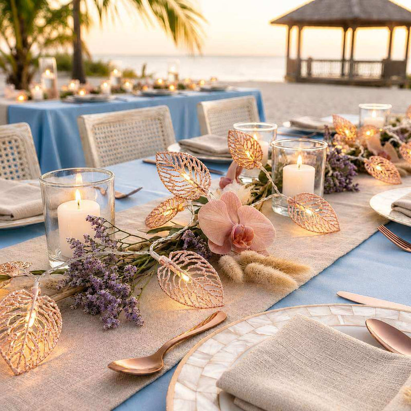 Rose gold leaf string lights decorating a beachside wedding table - thumbnail number 4