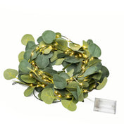 A battery-operated eucalyptus leaf garland with warm white LED string lights on a white background - thumbnail number 2