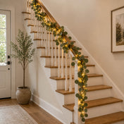 A 7ft battery-operated eucalyptus garland with 20 warm white LED lights on a staircase railing - thumbnail number 8