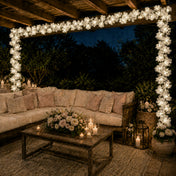 Cherry blossom garland string lights framing an outdoor patio seating area - thumbnail number 5