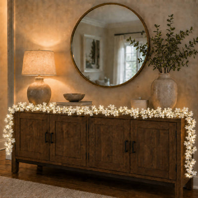 White cherry blossom garland string lights draped over a wooden credenza - thumbnail number 9