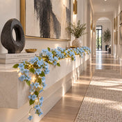 Blue jasmine flower garland with fairy lights on a hallway console table - thumbnail number 10