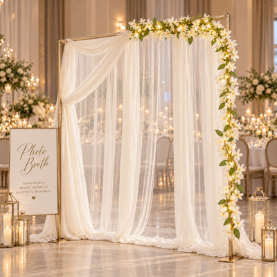White jasmine flower garland with fairy lights decorating a photo booth arch - thumbnail number 2