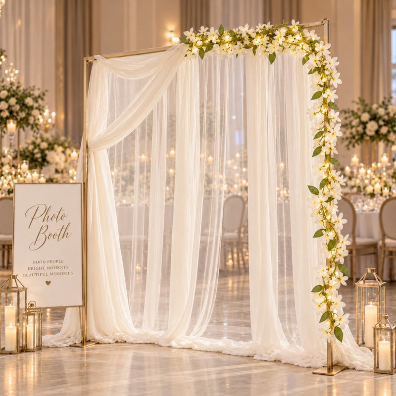 White jasmine flower garland with fairy lights decorating a photo booth arch - thumbnail number 2