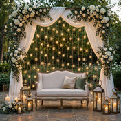Vertical string lights hanging behind an outdoor wedding sofa setup - thumbnail number 4