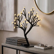 Black cherry blossom tree centerpiece with warm white LED lights on a side table - thumbnail number 8