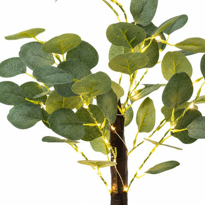 Close-up of artificial eucalyptus branches wrapped with warm white LED fairy lights - thumbnail number 3
