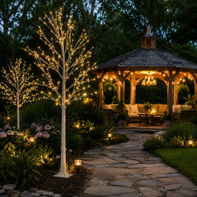 Two 6ft lighted birch trees with warm white LEDs standing on a garden path near a gazebo - thumbnail number 10