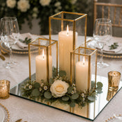 Lit pillar candles in gold-framed glass holders on a square mirror tray with a rose - thumbnail number 3