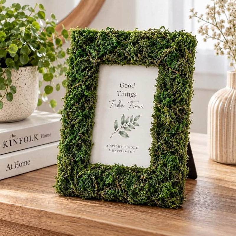 Picture frame covered in green reindeer moss with an inspirational quote on a wooden table - thumbnail number 10