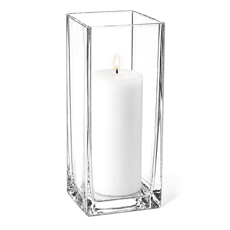 Warm candle flame glowing from within a tall glass Square Pillar Candle Holder 12" on white - thumbnail number 3