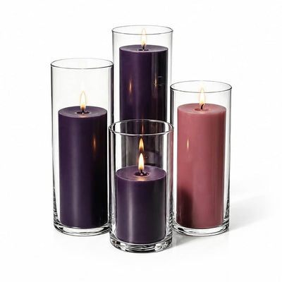 Lit Advent Pillar Candles & Cylinder Holders set of 4 on a white backdrop - thumbnail number 2