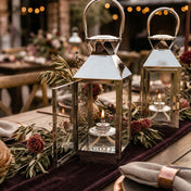 Lit fuel cells inside silver lanterns with floral table decor - thumbnail number 3