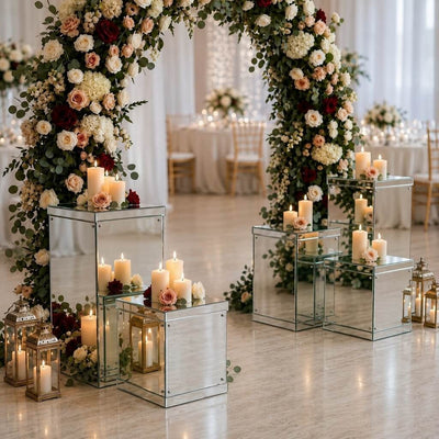 Silver mirrored acrylic display boxes holding candles under a large floral wedding arch - thumbnail number 5