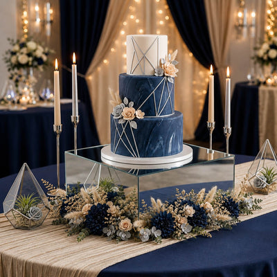Geometric navy wedding cake on a silver mirror acrylic riser surrounded by florals - thumbnail number 4