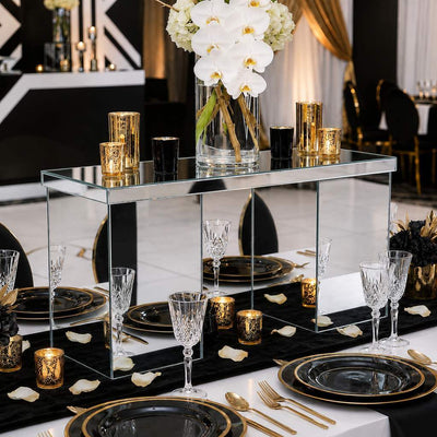 Mirrored rectangular centerpiece stand styled with candles and white orchids on a black and gold table - thumbnail number 4