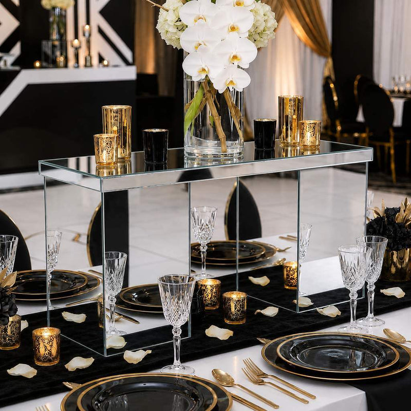 Mirrored rectangular centerpiece stand styled with candles and white orchids on a black and gold table - thumbnail number 4