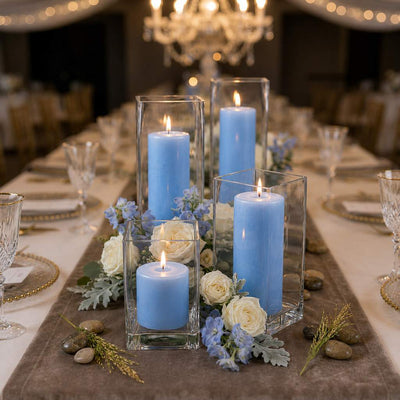 Lit light blue candles in a square holder setup on a table runner with white roses - thumbnail number 3