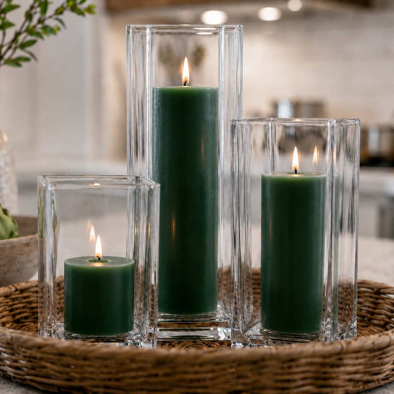 Three lit dark green candle and square holder sets arranged inside a woven wicker basket tray - thumbnail number 6