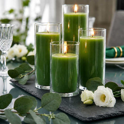 Four green pillar candles in glass vases on a slate tray with white flowers and eucalyptus - thumbnail number 5